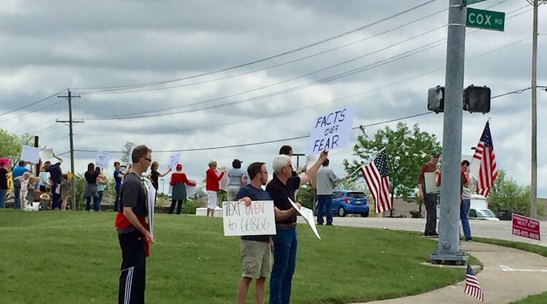 More than three dozen protesters in West Chester Twp. joined others across the state Saturday to air their objections to Ohio Gov. Mike DeWine’s anti-coronavirus measures. The participants carried signs and urged motorists to honk their horns in support of their cause as they stood along the northeast corner of the busy Tylersville and Cox Road intersection in the Butler County township. Photo By Michael D. Clark/Journal-News