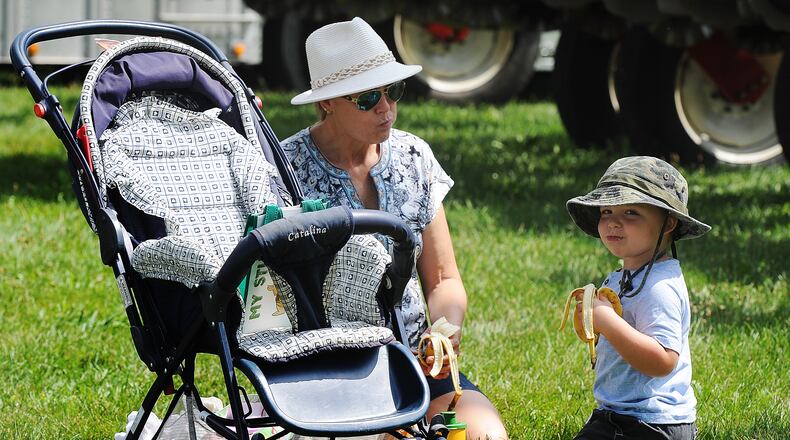 Beth Ann Miller and her grandson Logan Miller, age3, enjoy a snack at the Miami County Fair Wednesday, Aug. 16, 2023. MARSHALL GORBY\STAFF