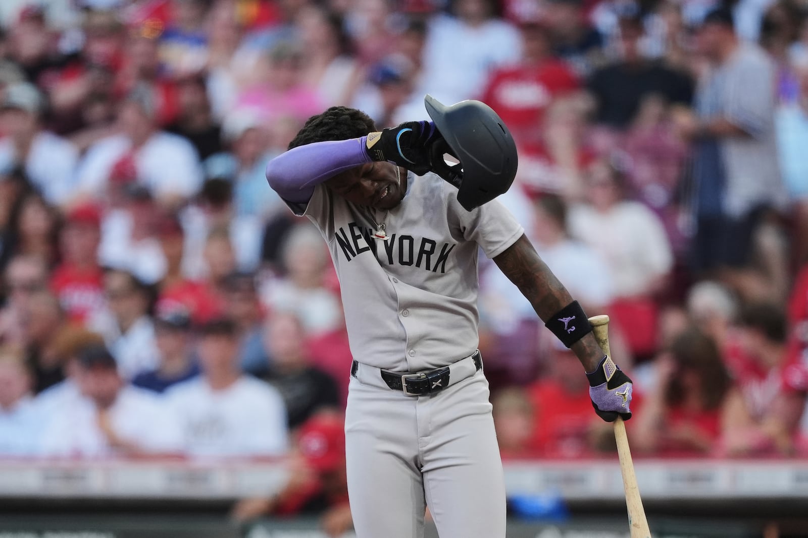 New York Yankees' Jazz Chisholm Jr. wipes his his face during the third inning pauses of a baseball game against the Cincinnati Reds, Monday, June 23, 2025, in Cincinnati. (AP Photo/Joshua A. Bickel)
