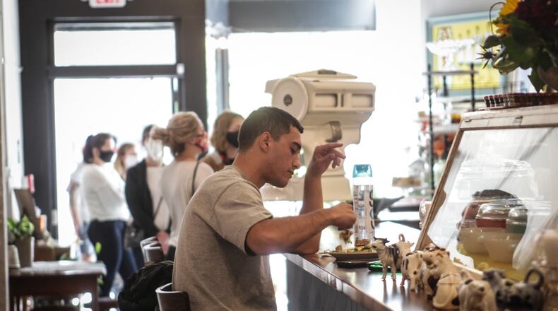 Graham Hunter, from Dayton, eats at the newly opened, Salt Block Biscuit Company on Third Street in the Fire Block District Tuesday September 22,2020.