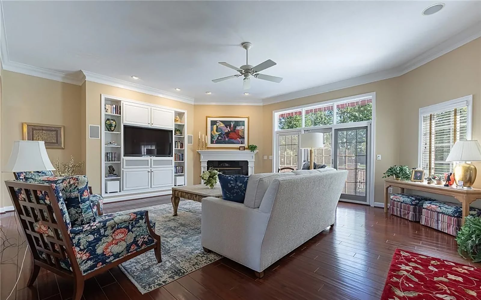 The great room has hardwood flooring, crown molding, a ceiling fan, gas fireplace and built in entertainment center. Sliding glass doors open to the back patio. CONTRIBUTED