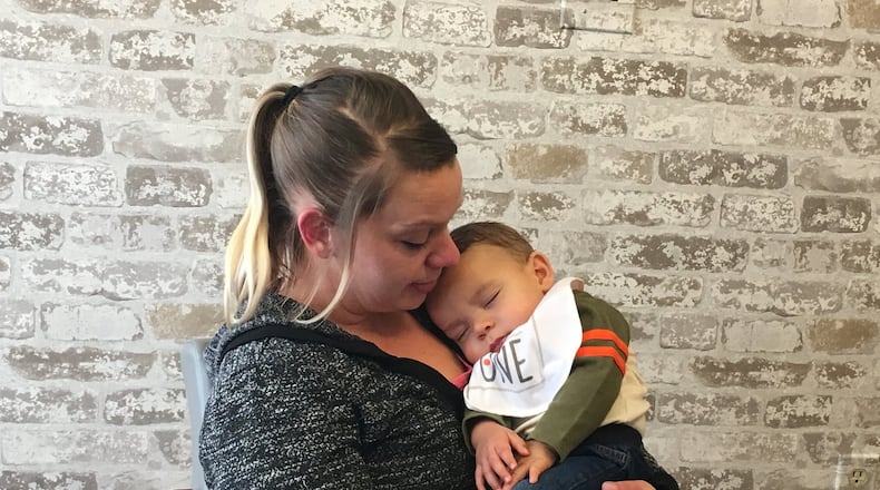 Jennifer Clay holds her son Jaden while talking about her decade-long battle with drug addiction. KATIE WEDELL/STAFF