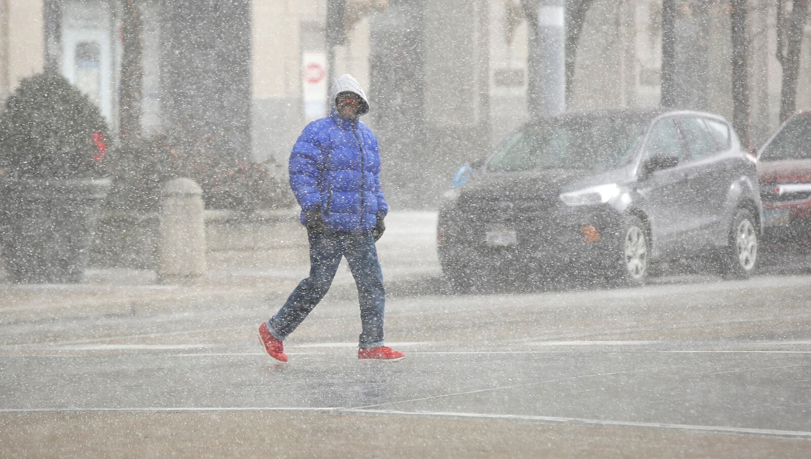 Snow squalls, brief heavy snowfall with gusty winds, blew through Dayton all day on Tuesday.  The snow squall briefly cut visibility and obscured the city skyline and were often followed by short periods of sunshine.  TY GREENLEES / STAFF