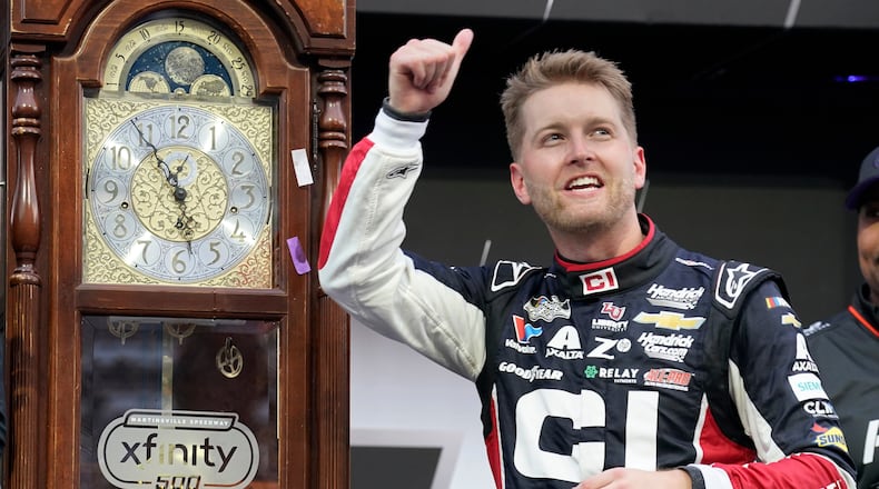 William Byron celebrates in Victory Lane after winning a NASCAR Cup series auto race in Martinsville, Va., Sunday, Oct. 26, 2025. (AP Photo/Chuck Burton)