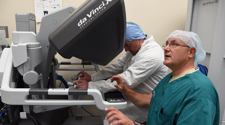 Maj. Scott Thallemer, perioperative nurse and robotics coordinator with the Institute for Defense Robotic Surgical Education (InDoRSE), trains Maj. Gen. Timothy Leahy, 2nd Air Force commander, on the da Vinci X surgical system used in robotics surgery at the Keesler Medical Center, Sept. 26, 2017, on Keesler Air Force Base, Miss. InDoRSE is working with the Air Force Research Lab to understand trust between surgical teams and the robot to improve on the training program. Trust is a key factor in determining proper use of such innovative technology as surgical robots. (U.S. Air Force photo/Kemberly Groue)