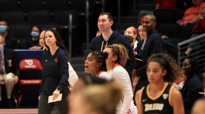 Dayton coaches, including Shauna Green, left, react after a basket against Toledo on Wednesday, Nov. 17, 2021, at UD Arena. David Jablonski/Staff