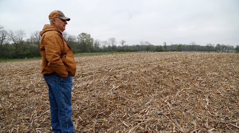 Ohio land values increased slightly in January compared to a year ago, from a $7,100 average sale price per acre to $7,300. In this May 2016 photo, Roderick Yocum looks over land on his Champaign County farm. BILL LACKEY/STAFF