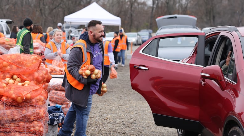 CareSource and Dayton Foodbank partnered for a mass food distribution event on Thursday, Nov. 20 at Dixie Twin Drive-In Theater. SICSA also distributed dog and cat food to those with pets. BRYANT BILLING/STAFF