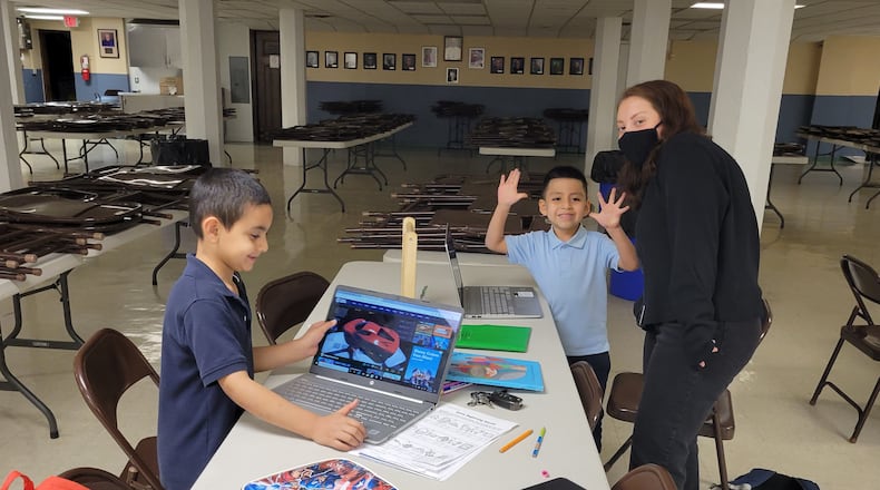 Students gather around a table for one of El Puente's after-school programs, which are held for Latino families in the Dayton area. CONTRIBUTED