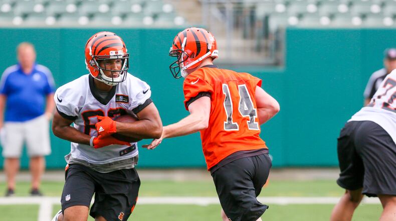 Bengals quarterback Andy Dalton (14) and wide receiver Tyler Boyd (83) participate in a team practice at Paul Brown Stadium, Tuesday, June 13, 2017. GREG LYNCH / STAFF