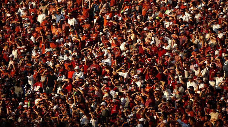 Texas and Oklahoma fans watch during the second half of an NCAA college football game Saturday, Oct. 14, 2017, in Dallas. Oklahoma won 29-24. (AP Photo/Ron Jenkins)