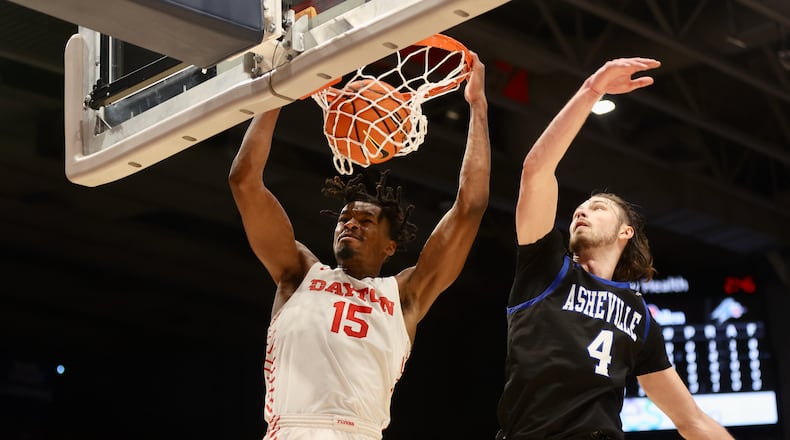 Dayton's DaRon Holmes II dunks against UNC Asheville in the first half on Saturday, Dec. 10, 2022, at UD Arena. David Jablonski/Staff