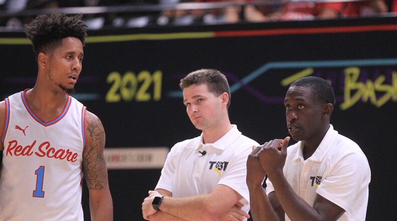 Darrell Davis, Joey Gruden and Jeremiah Bonsu, of Red Scare, watch the action during a game aainst Category 5 in the second round of The Basketball Tournament on Sunday, July 25, 2021, at the Covelli Center in Columbus. David Jablonski/Staff