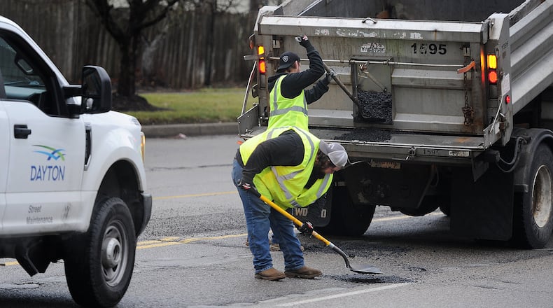 City of Dayton Street Maintenance crews fill potholes along Wilmington Ave. near Wayne Ave. Friday, Jan. 26, 2024. MARSHALL GORBY\STAFF