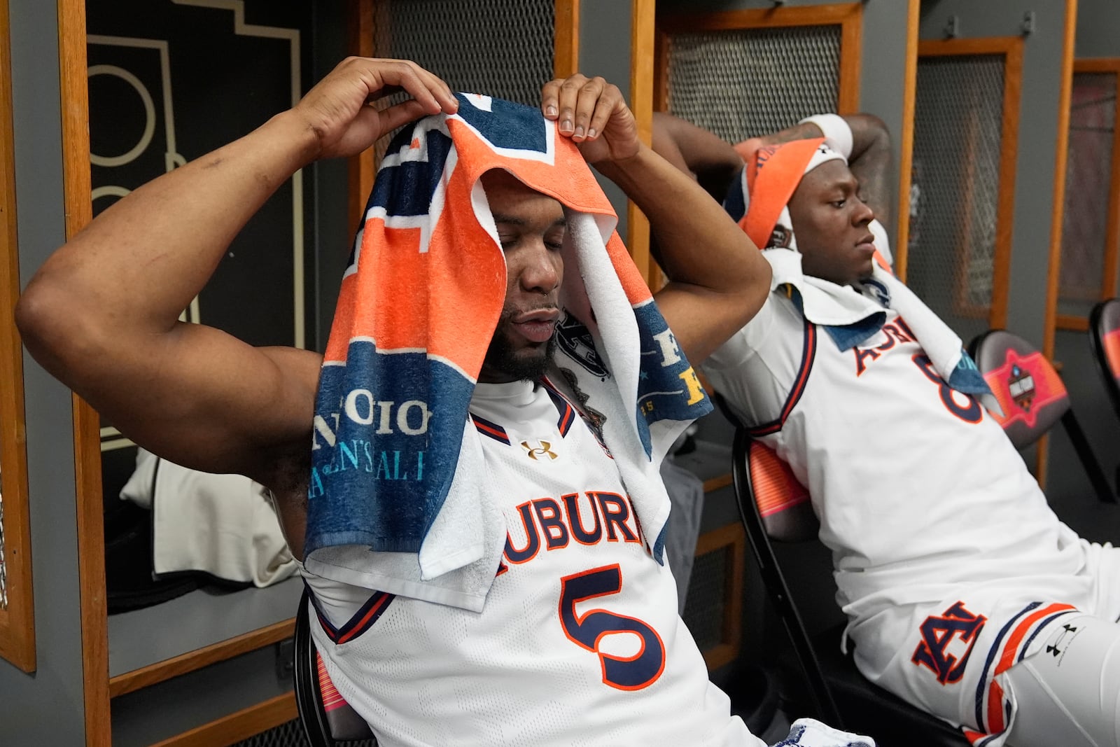 Auburn's Chris Moore (5) and Ja'Heim Hudson sit in the locker room after Auburn lost to Florida in the national semifinals at the Final Four of the NCAA college basketball tournament, Saturday, April 5, 2025, in San Antonio. (AP Photo/Stephanie Scarbrough)