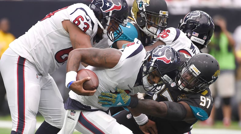 Houston Texans quarterback Deshaun Watson (4) is sacked by Jacksonville Jaguars defensive tackle Malik Jackson (97) during the second half of an NFL football game Sunday, Sept. 10, 2017, in Houston. (AP Photo/Eric Christian Smith)