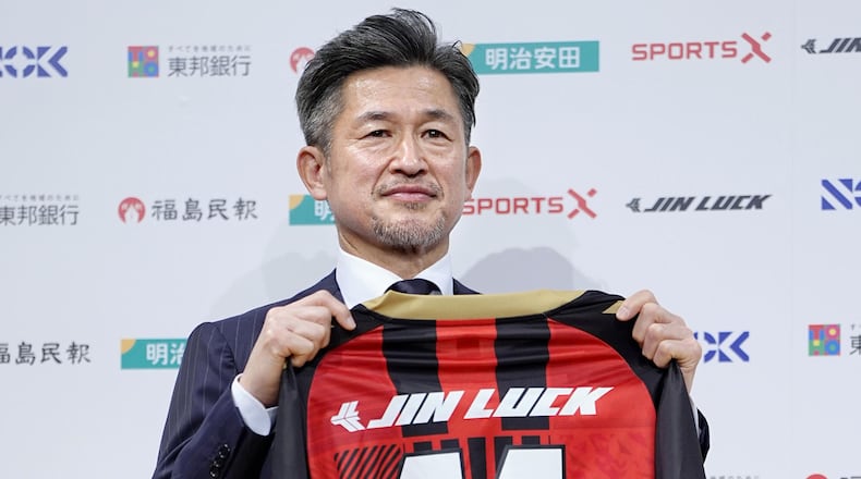 Japanese soccer player Kazuyoshi Miura poses with uniform of third-division J-League team Fukushima United. during a press conference in Tokyo, Japan, on Jan. 9, 2026. (Yuya Shino/Kyodo News via AP)