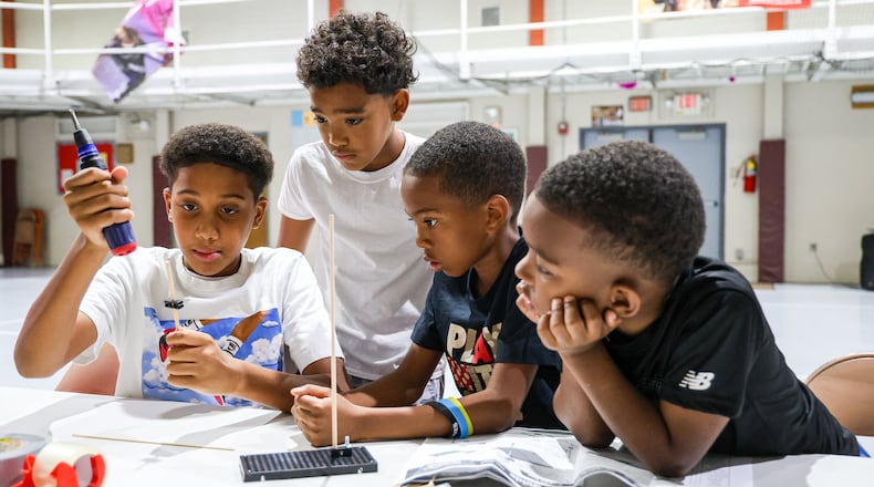 Students in Fail Me Not Tutoring work on a windmill project on Wednesday, July 23 at the summer camp, which was held at Trotwood Preparatory and Fitness Academy property. BRYANT BILLING / STAFF