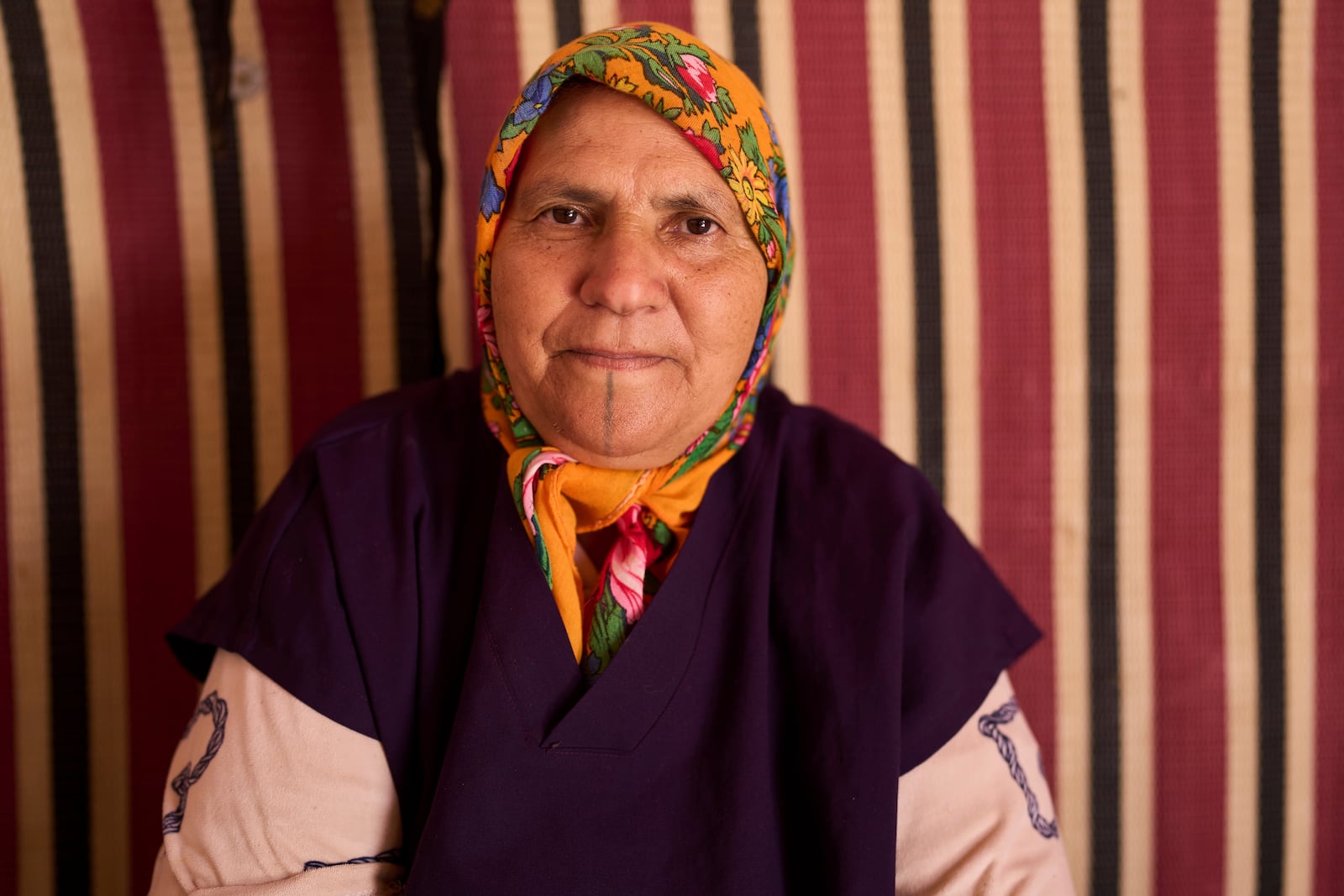 Fatima Bensaid, who works at a cooperative that extracts and produces argan oil and products, poses for a portrait, in Essaouira, Morocco, Thursday, May 22, 2025. (AP Photo/Mosa'ab Elshamy)