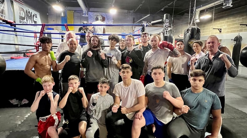 The stable of boxers at Daniel Meza-Cuadra’s DMC Boxing Academy in Centerville includes five Turkish boxers, four of whom are pictured here. (Front row, right to left) Khalim Eminov,  Aidan Shaibov, Ravshan Akhmabov, Aydin Idrisov. (Not pictured Mohamed Chibi). Gym owner and head trainer Meza-Cuadra is in second row, second from left (black shirt), The DMC boxers will put on a 13-bout exhibition show to benefit Turkish earthquake victims this Sunday at 2p.m. at the Ahiska Turkish American Community Center, 1306 E. Fifth Street. CONTRIBUTED