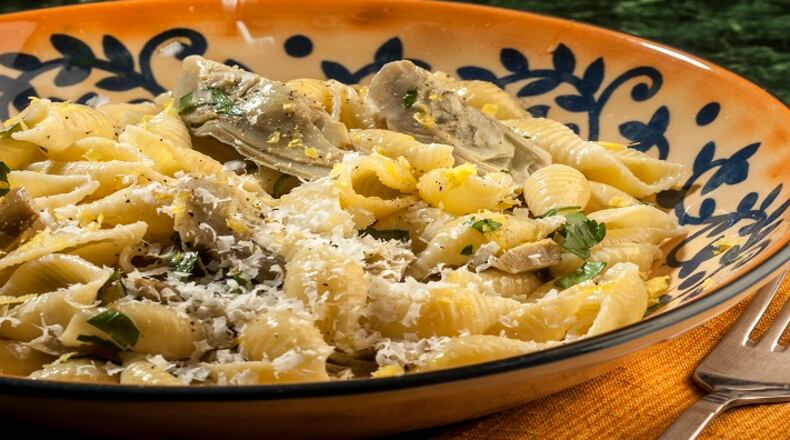 Baby artichokes get a generous dusting of grated Romano cheese in this pasta dish, enriched with cream and enlivened by fresh lemon.   (Bill Hogan/Chicago Tribune/TNS)