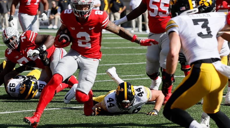 Ohio State receiver Emeka Egbuka, left, runs after catching a pass against Iowa during the first half of an NCAA college football game Saturday, Oct. 22, 2022, in Columbus, Ohio. (AP Photo/Jay LaPrete)