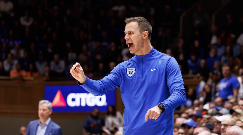 Duke head coach Jon Scheyer shouts towards the court during the second half of an NCAA college basketball game against Virginia in Durham, N.C., Saturday, Feb. 28, 2026. (AP Photo/Ben McKeown)