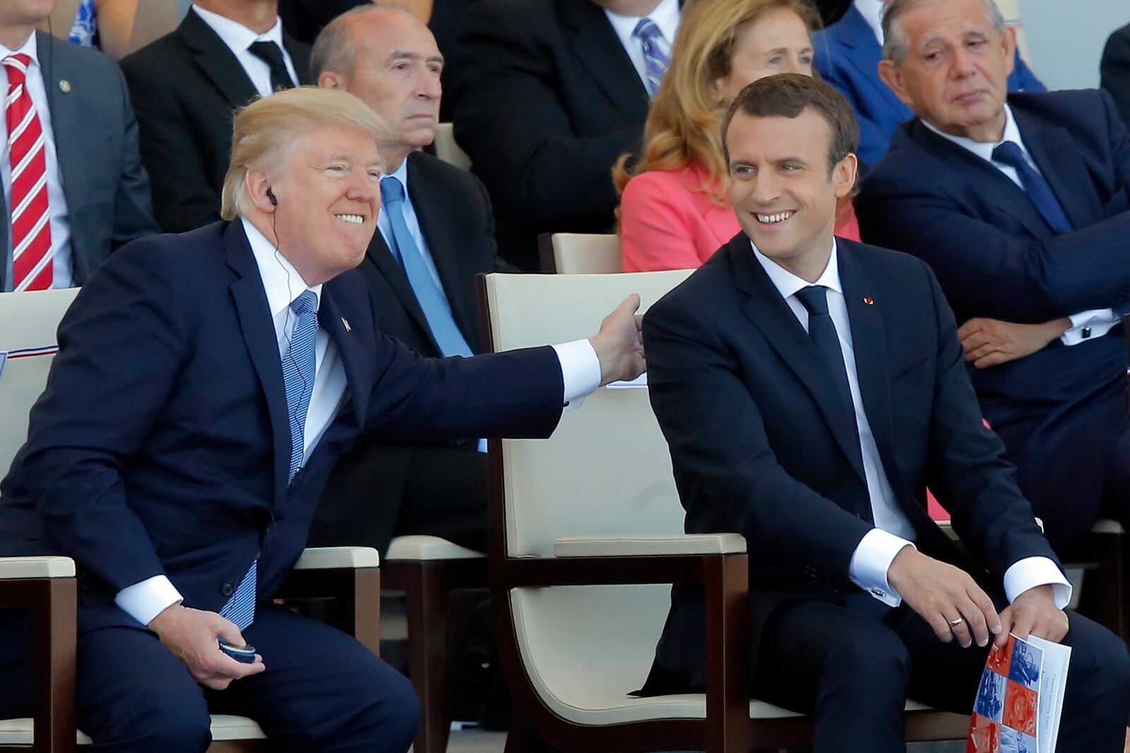 FILE - French President Emmanuel Macron, right, and U.S. President Donald Trump attend the traditional Bastille Day military parade July 14, 2017, on the Champs Elysees, in Paris. (AP Photo/Michel Euler, File)
