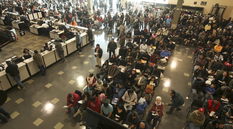 Hundreds of people without legal status wait inside the Department of Motor Vehicles office in Stanton, Calif., for an opportunity to obtain a license to drive on Friday, Jan. 2, 2015. (Mark Boster/Los Angeles Times/TNS)