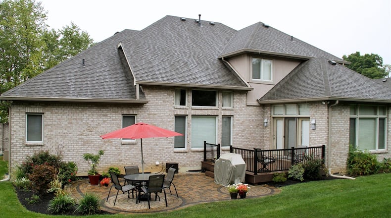 The lower level has been finished into a recreation room with kitchenette/bar area and gas fireplace. Etched-glass doors open into a projector theater room. A possible fifth bedroom and a full bathroom finish out the lower-level features.