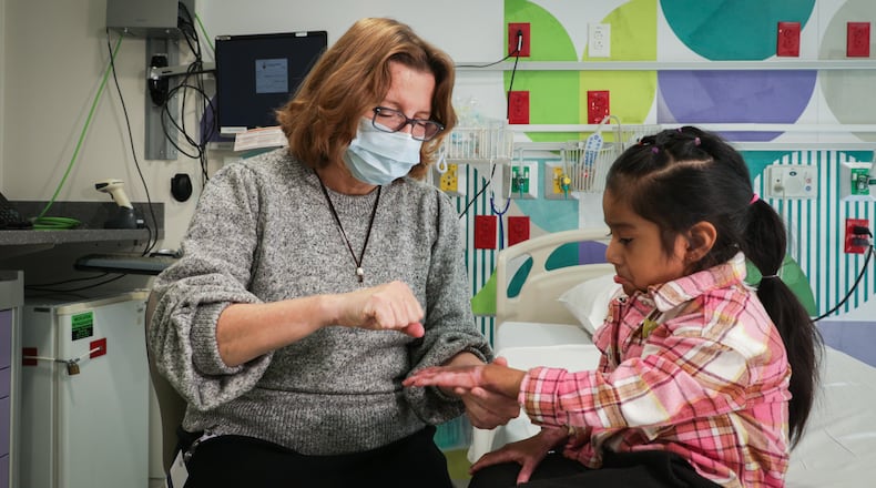 Dr. Petra Warner, chief of staff at Shriners Children’s Ohio, treats a burn patient at Shriners' Dayton hospital. CONTRIBUTED