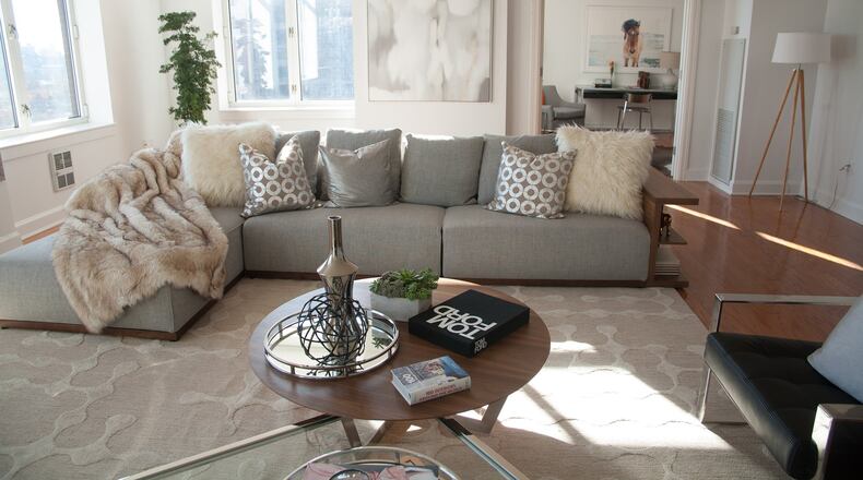 A low, light colored sectional sofa helps keep this living room open and bright. (Hannah Rokes)