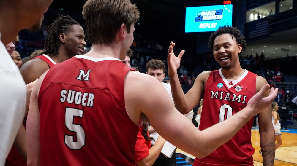 Miami (Ohio) guard Peter Suder (5) celebrates with teammate Eian Elmer (0) following a First Four college basketball game against SMU in the NCAA Tournament in Dayton, Ohio, Wednesday, March 18, 2026. (AP Photo/Jeff Dean)