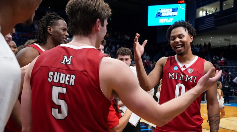 Miami (Ohio) guard Peter Suder (5) celebrates with teammate Eian Elmer (0) following a First Four college basketball game against SMU in the NCAA Tournament in Dayton, Ohio, Wednesday, March 18, 2026. (AP Photo/Jeff Dean)