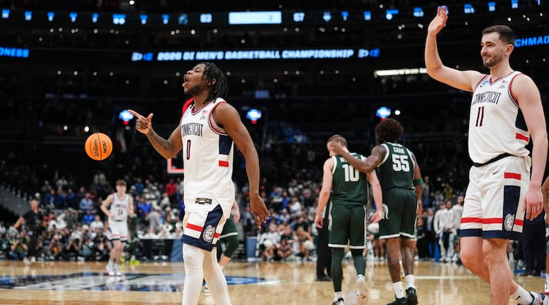 UConn guard Malachi Smith (0) and UConn forward Alex Karaban (11) celebrate their win against Michigan State in the Sweet 16 of the NCAA college basketball tournament, Saturday, March 28, 2026, in Washington. (AP Photo/Abbie Parr)