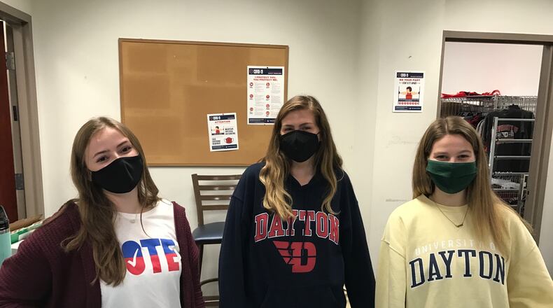 UDayton Votes table set up on campus Friday. Left to right are students Erin DeCero, Abby Medler and Hannah Hoby. Tom Archdeacon/STAFF