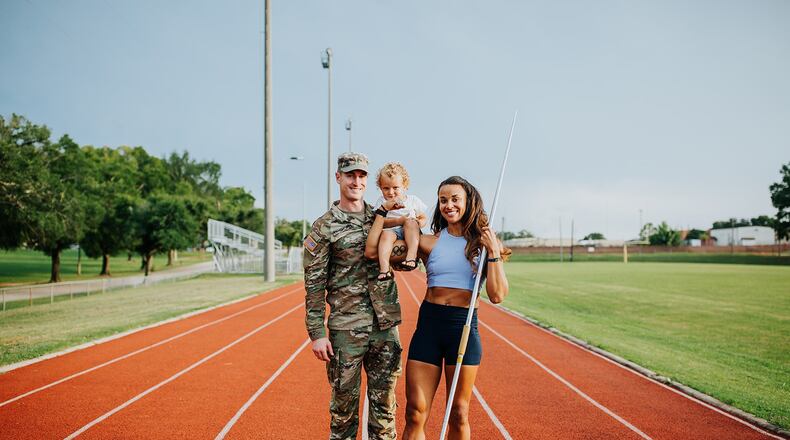 U.S. Army Warrant Officer 1 Devon Langhorst, a Blackhawk helicopter pilot and a former University of Dayton football standout, and his wife, former Olympic heptathlete Chantae McMillan, who will try to make the Tokyo-bound U.S. team this year in the javelin throw, pose last year with their son Otto at Fort Rucker in Alabama. Photo courtesy of Jenny Haury Photography