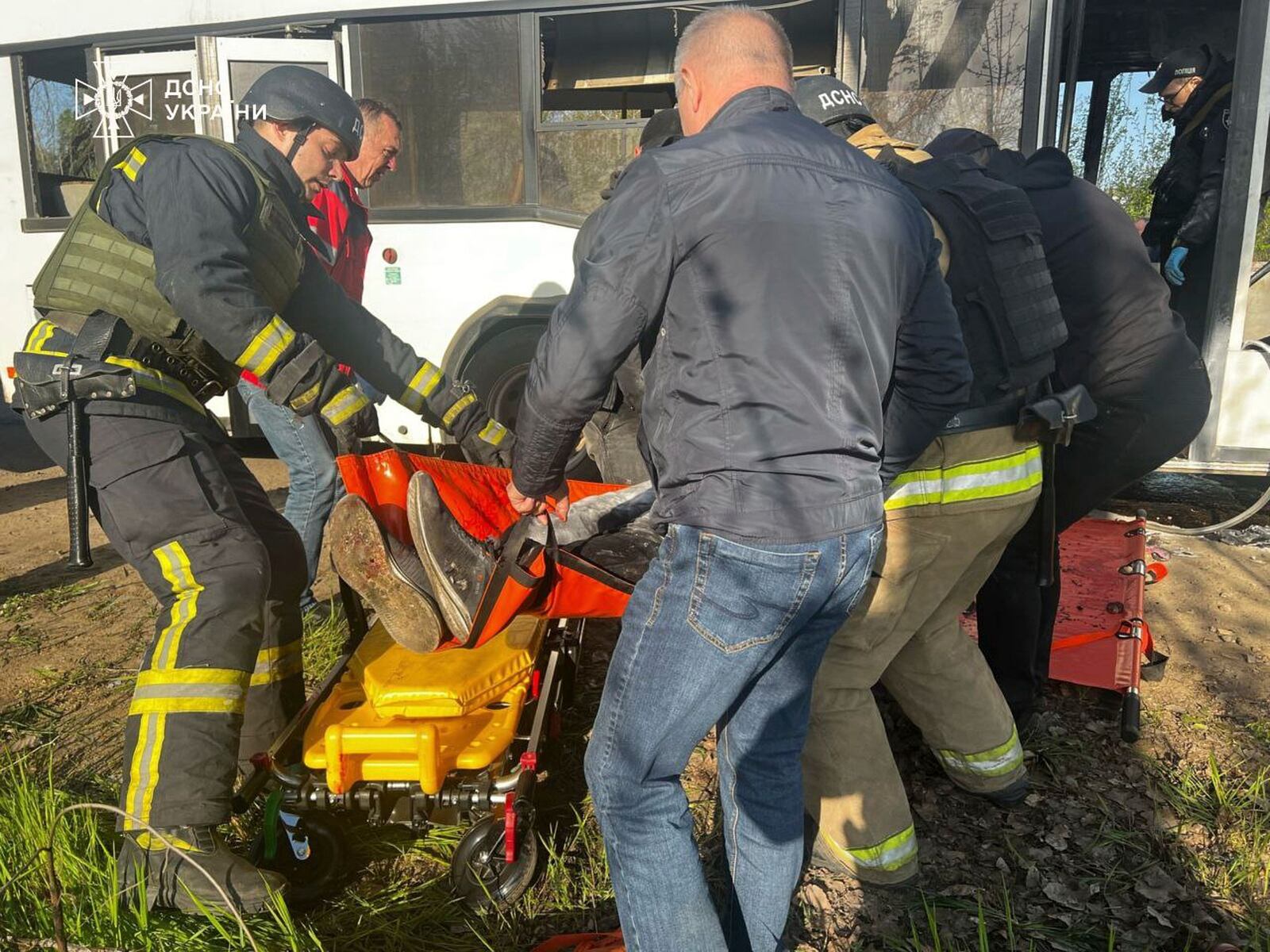 In this photo provided by the Ukrainian Emergency Service, rescuers carry out bodies of passengers after a Russian drone hit a public bus in Marhanets, Dnipropetrovsk region, Wednesday, April 23, 2025. (Ukrainian Emergency Service via AP)