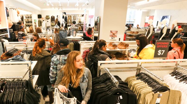 Shoppers explore the new H&M at Liberty Center during their grand opening event at Liberty Center, Thursday, Mar. 31, 2016. GREG LYNCH / STAFF