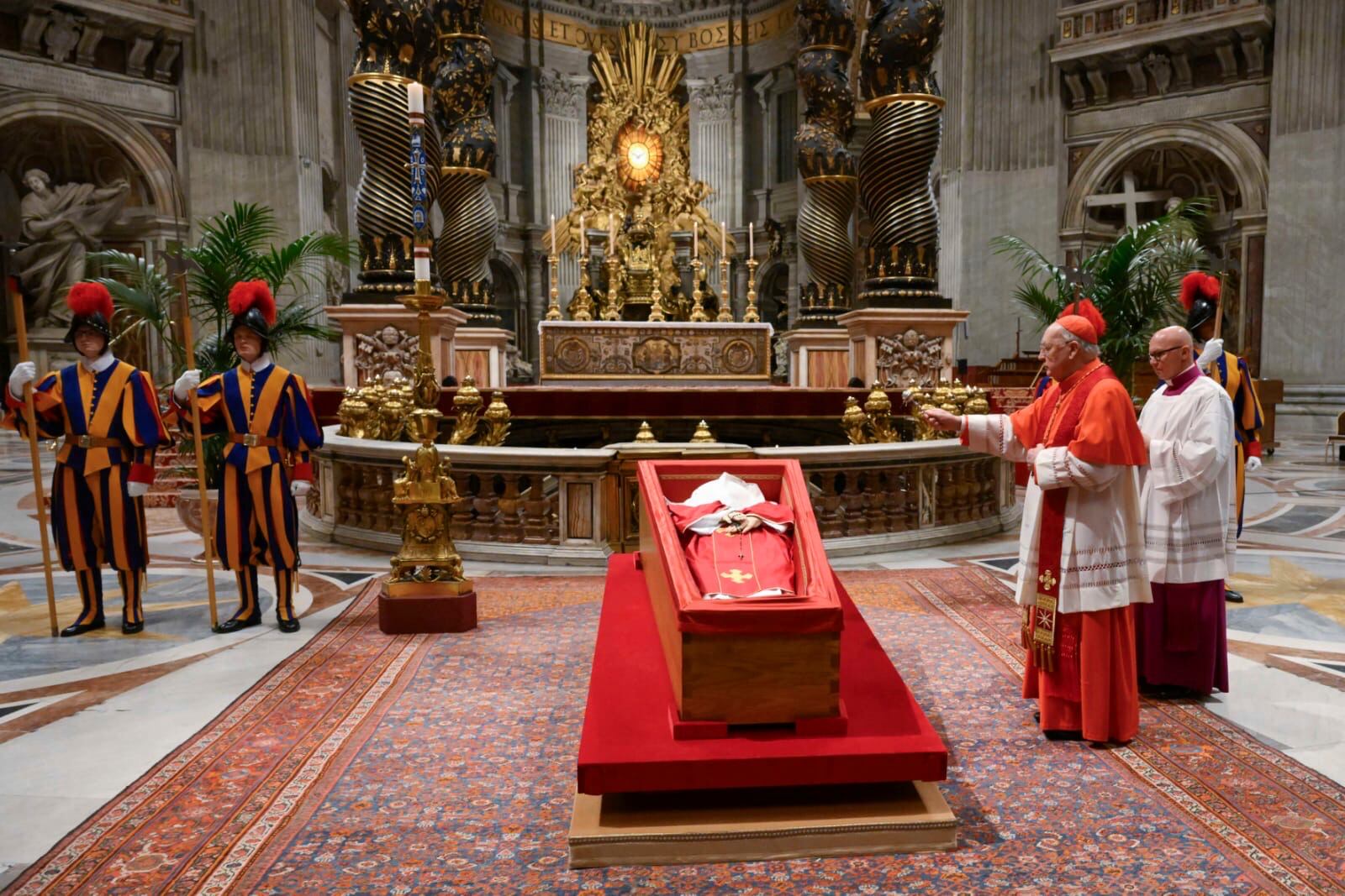 Cardinal Camerlengo Kevin Joseph Farrel, right, asperges the body of late Pope Francis with holy water before closing his casket in St. Peter's Basilica at the Vatican Friday, April 25, 2025. (Vatican Media via AP)