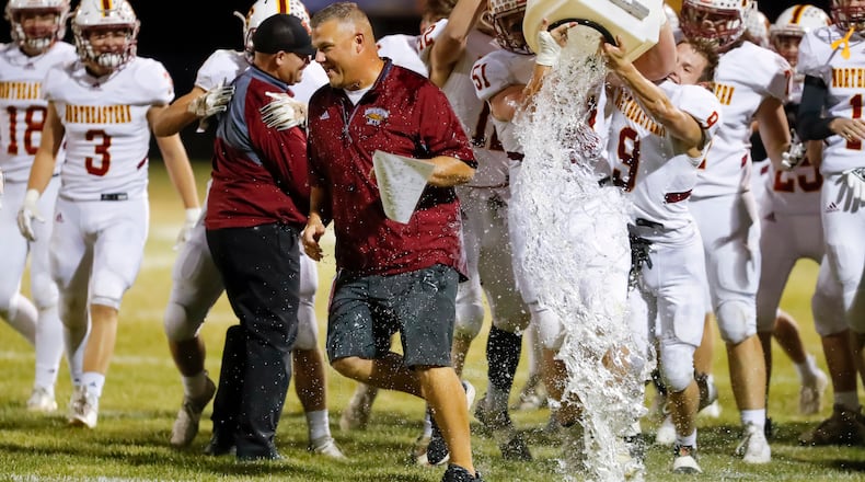 Northeastern High School football coach Jake Buchholtz gets doused with water after the Jets beat Fairbanks 42-7 on Friday, Oct. 21, 2022 at Kyre Field in Milford Center. CONTRIBUTED PHOTO BY MICHAEL COOPER