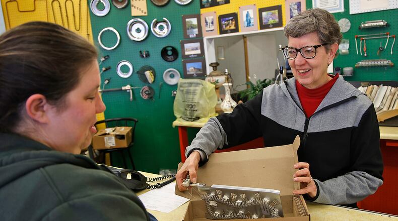 Bonnie Proper, the owner of Mr. Handy Appliance Parts Center, show Erin Sweitzer the heating element for her clothes dryer she ordered Thursday, Jan. 11, 2024. Erin has been coming into the Mr. Handy parts store and working with Bonnie since she was a young girl. BILL LACKEY/STAFF