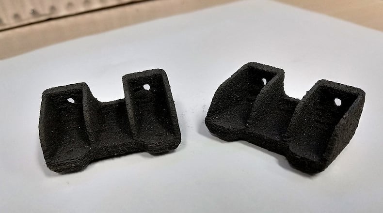 Researchers at the Air Force Research Laboratory have demonstrated the ability to additively manufacture high-temperature polymer composites for use in extreme environments. The material, made with carbon fiber infused polymer resin and selective laser sintering, has potential use in engine components and on the leading and tail edges of fighter jets in the future. (Air Force photo/Dr. Hilmar Koerner)