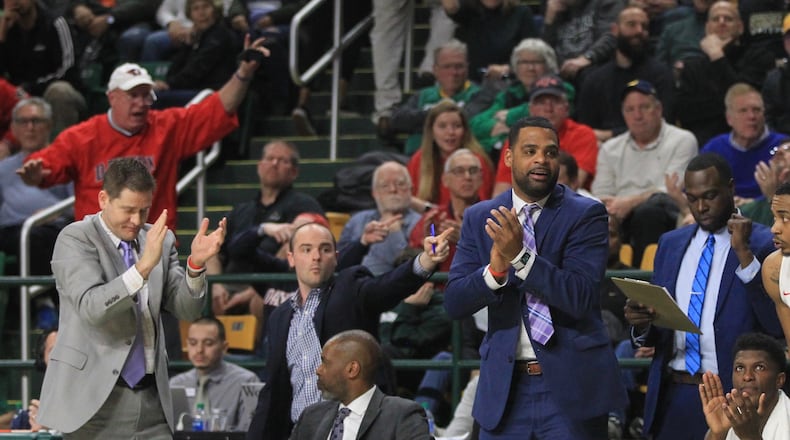 Dayton coaches celebrate after a basket against George Mason on Tuesday, Feb. 25, 2020, at EagleBank Arena in Fairfax, Va. David Jablonski/Staff