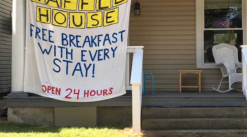 A sign hangs on a house in the student neighborhood near UD’s campus.