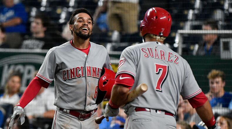KANSAS CITY, MO - JUNE 12: Billy Hamilton #6 of the Cincinnati Reds celebrates with Eugenio Suarez #7 after scoring on a Joey Votto three-run triple in the 10th inning against the Kansas City Royals at Kauffman Stadium on June 12, 2018 in Kansas City, Missouri. (Photo by Ed Zurga/Getty Images)