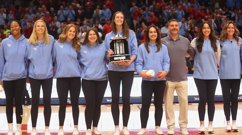 The Dayton volleyball team is honored during a men's basketball game against Saint Louis on Tuesday, March 4, 2025, at UD Arena. David Jablonski/Staff