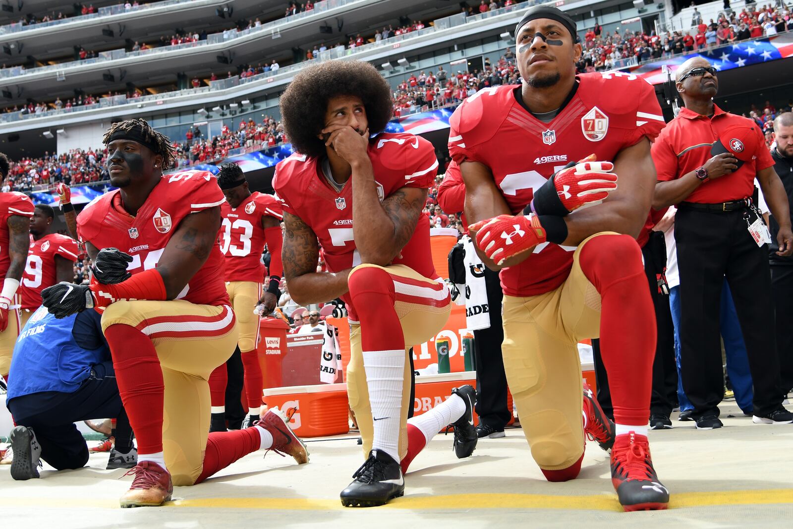 SANTA CLARA, CA - OCTOBER 02:   (L-R) Eli Harold #58, Colin Kaepernick #7 and Eric Reid #35 of the San Francisco 49ers kneel on the sideline during the anthem prior to the game against the Dallas Cowboys at Levi's Stadium on October 2, 2016 in Santa Clara, California. (Photo by Thearon W. Henderson/Getty Images)