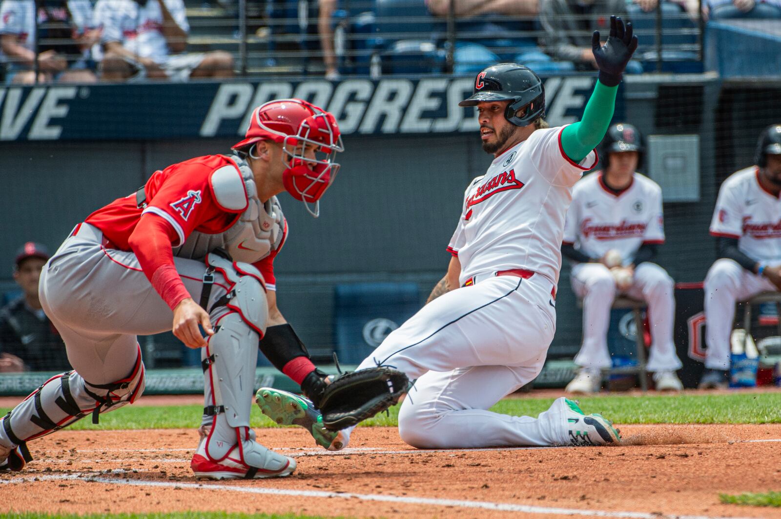 Cleveland Guardians' Gabriel Arias scores on a sacrifice fly by Steven Kwan as Los Angeles Angels' Logan O'Hoppe waits for the throw during the third inning of a baseball game, Sunday, June 1, 2025, in Cleveland. (AP Photo/Phil Long)