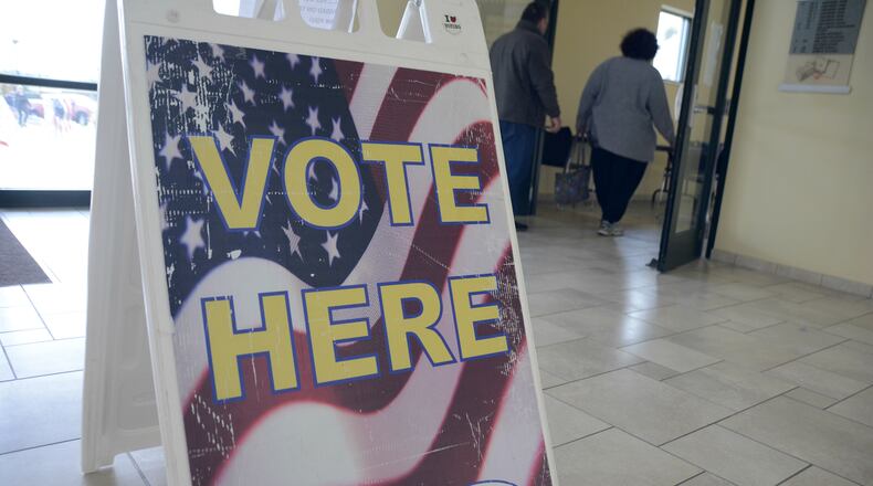 Butler County voters walk into the board of elections office in Hamilton to cast an early vote ballot in the 2018 general election. MICHAEL D. PITMAN/STAFF
